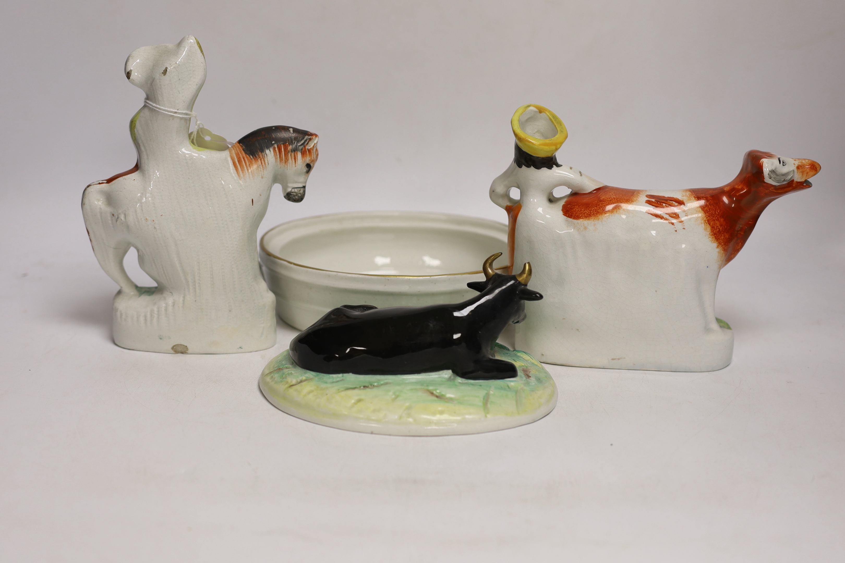 A Victorian Staffordshire cow tureen and cover, and five other Staffordshire figures, largest 18cm wide
